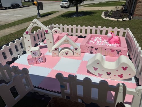 Customer's pink and white Soft Play Set with a Minnie Mouse theme, including arches, blocks, and a ball pit, set up outdoors.