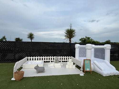 Customer's white Soft Play - Set-Basic set up outdoors in a play zone with a ball pit and bounce house.