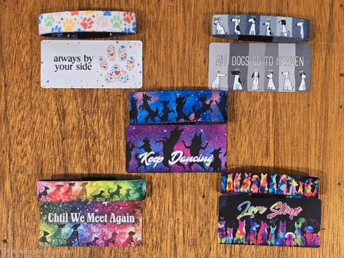 Customer's five colorful Dog Pack bracelets and matching message cards displayed on a wooden surface.