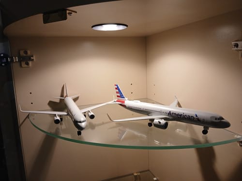 Reviewer's SKYMARKS AMERICAN A321NEO model displayed on a glass shelf next to another model for comparison.