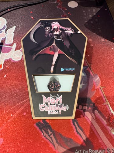 Customer's Mori Calliope Dice Set in its black, coffin-shaped display box on a desk mat.