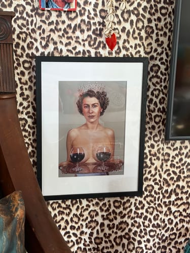 Customer's framed 'Majestic' art print hanging on a bold leopard-print wall.