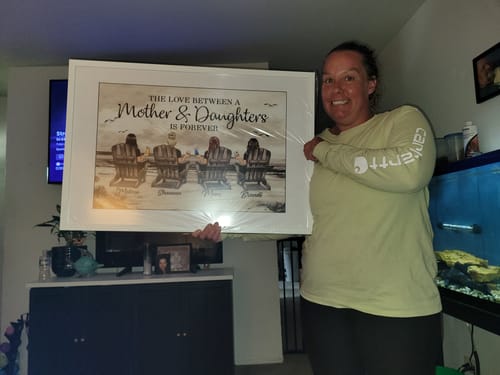 Reviewer holding the large, framed personalized horizontal poster in a living room.