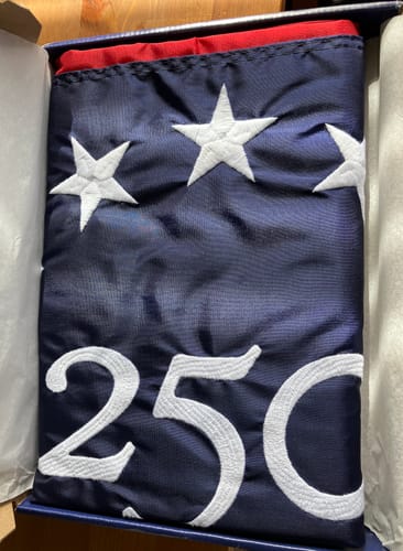 Customer's close-up of the folded America 250™ flag showing the white embroidered stars and "250" detail.