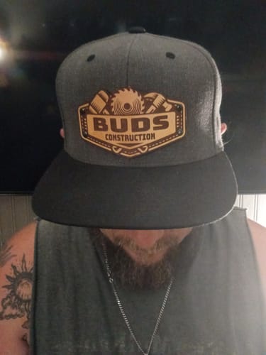 Reviewer wearing a custom grey and black Work Hat Construction with a 'BUDS CONSTRUCTION' leather patch.