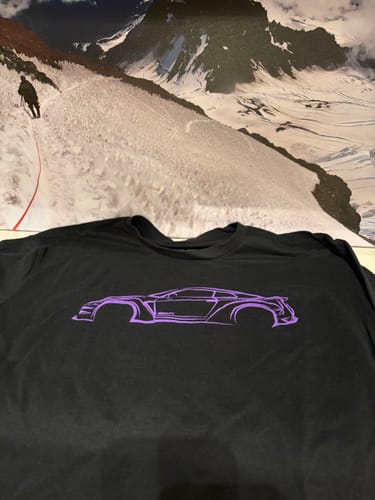 Customer's black 80Eighty® DCG88 Shirt laid flat, showing the purple sports car outline graphic.
