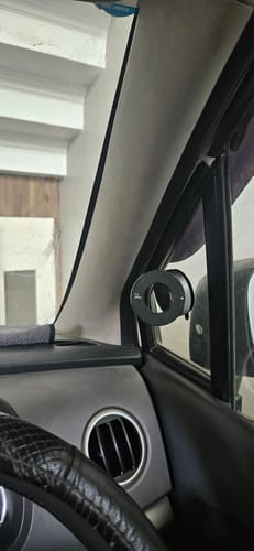 Customer's black 360° MagPro Magnetic Phone Holder mounted on the car's A-pillar by the window.