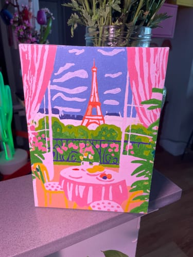 Customer's completed mini painting showing a colorful balcony view of the Eiffel Tower.