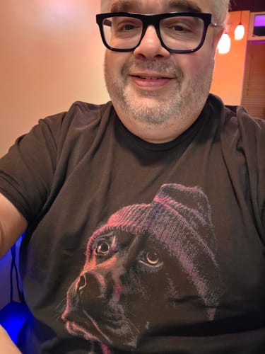 Reviewer wearing the black Low Light Lab t-shirt featuring a graphic of a dog in a beanie.