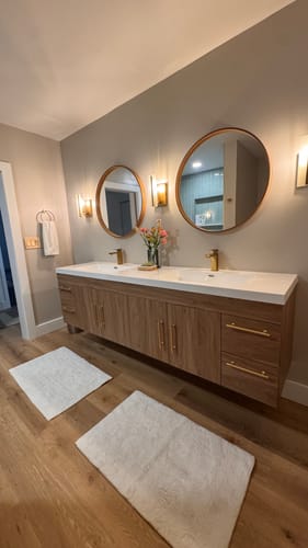 Customer's long Belgian Floating Vanity with a wood finish, installed in a modern bathroom.