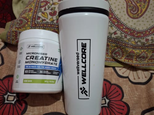 Reviewer's white tub of Wellcore Creatine Monohydrate and matching white shaker bottle.