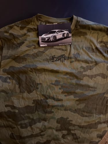 Reviewer's 80Eighty Camo LongSleeve Shirt laid flat, showing the forest camo pattern and chest logo.