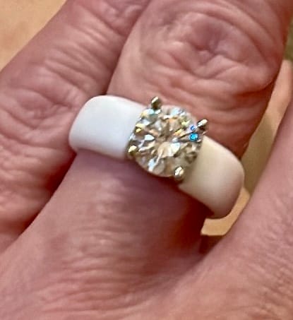 Close-up of a customer wearing the white silicone ring with a sparkly solitaire stone.
