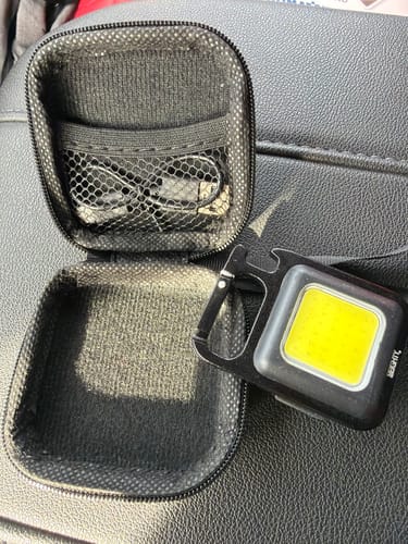 Customer's Mini 3-1 Flashlight Keychain shown with its open carrying case and the included USB charging cable.