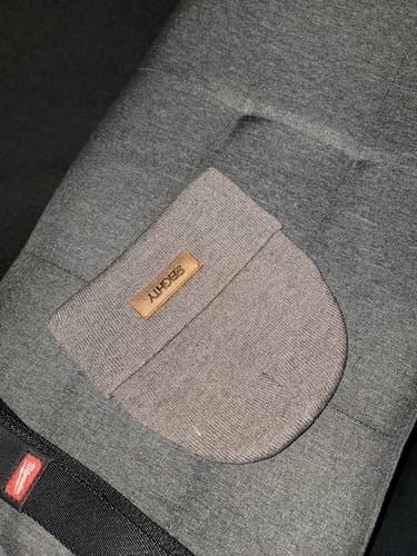 Customer's grey 80eighty® Brownstone Beanie with a brown logo patch, laid flat on a textured surface.