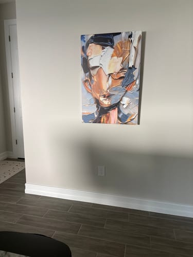 Customer's beautiful Beyond The Face Abstract Wall Art canvas hung on a neutral-colored wall in a room.