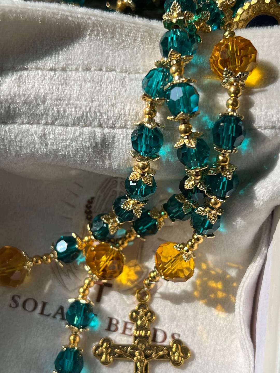 Customer photo review of SolaceBeads Peacock Blue & Champagne Crystal Rosary: A Prismatic Glow of Sacred Light