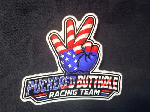 Customer's detailed custom vinyl sticker with a peace sign hand in an American flag pattern on a black surface.