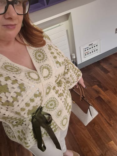 Customer wearing the Avril Green Crochet Knit Cardigan, styled with a ribbon to be worn as a wrap top.