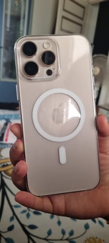 Customer holding their phone in the Anti Yellow Magsafe Clear Case, showing the clear back and white magnetic ring.