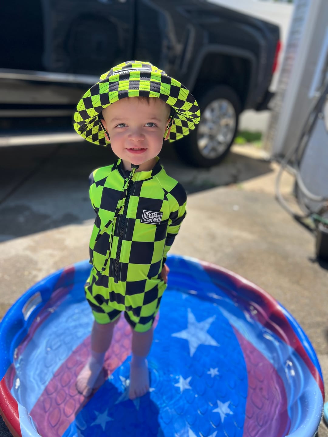 Customer photo review of UPF50+ Boys Swim Romper in Neon Electric Lime + Black Checkered