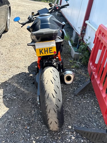 Reviewer's KTM Superduke 1390 with a tail tidy installed, showing the adjustable license plate flipped up.