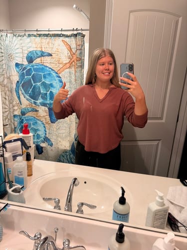 Reviewer taking a mirror selfie for their review. The Nura Pearl Silver Necklace is not visible.