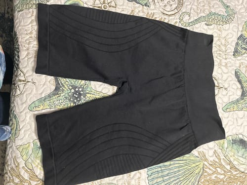 Customer's black 3D Anti-Cellulite shorts laid flat, showing the high waistband and textured pattern on the legs.
