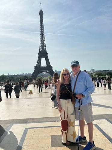 Customer posing in her Summer Solstice Patch Wide Leg Pants in front of the Eiffel Tower.