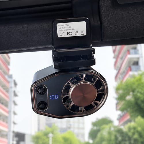 Black cooling fan clipped inside a car