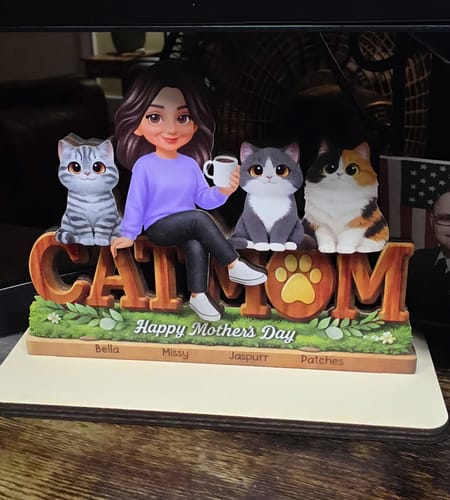 Customer's personalized 'Cat Mom' wooden plaque with a woman holding a mug and three cats sitting on the letters.