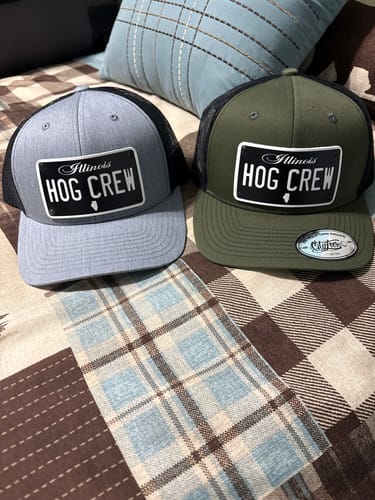 Customer showing two Illinois Blackout Plate Hats, one gray and one olive green, with 'HOG CREW' customization.