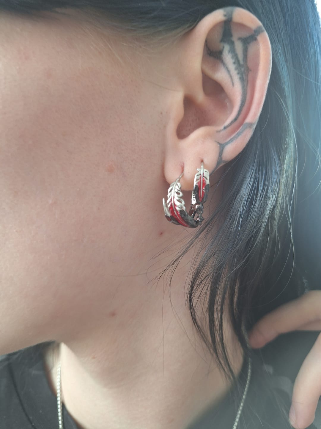 Customer photo review of "Soaring Cranes" Platinum Plated Asymmetrical Crane Statement Feather Spiral Earrings