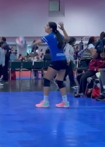 Reviewer wearing the Flame Socks:Reverse while playing volleyball on an indoor court.
