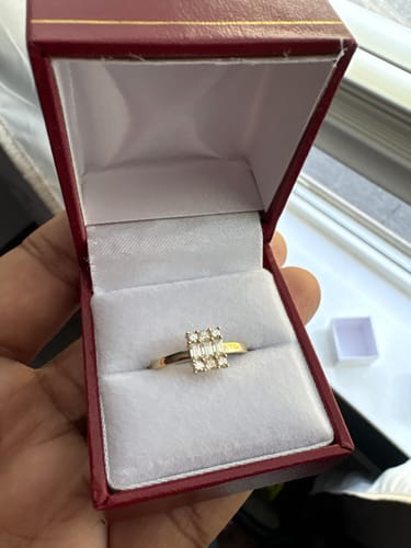 Customer holding an open red box to display the 14K Women's CZ Square Engagement Ring.