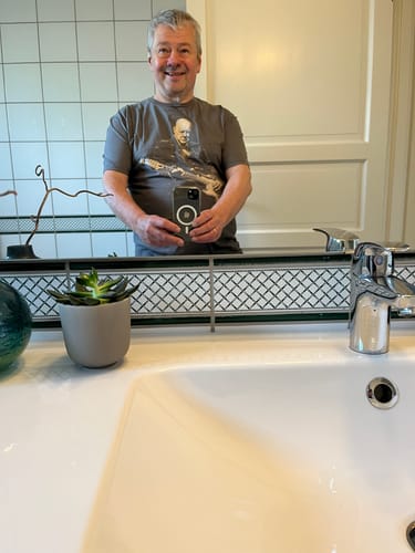 Reviewer taking a mirror selfie while wearing the grey Churchill Rock T-Shirt.