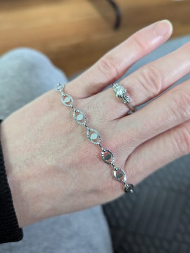 Reviewer showing the delicate Starlit Evil Eye Bracelet laid across their hand.