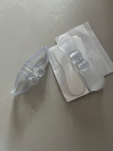 Customer shows the three clear appliance cord organizers they received from the 6-pack.