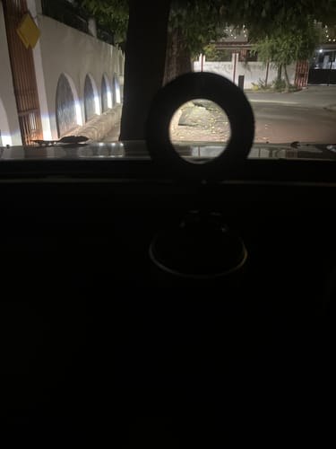 Customer's black MagPro Magnetic Phone Holder silhouetted on a car dashboard at night.