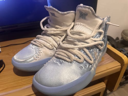 Customer's pair of Joker 2 "Denver" High shoes in a pretty light blue and white colorway, sitting on a wooden table.