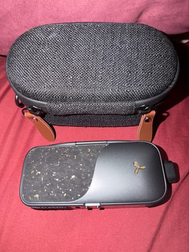 Customer's black LEGACY PRO 2 vaporizer with its cork fabric finish and textured carrying case.