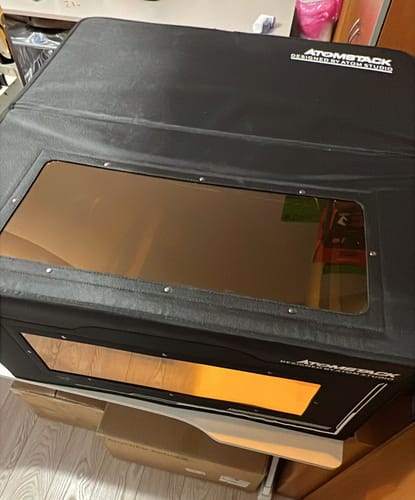 Reviewer's black AtomStack FB2 Enclosure, showing the large orange-tinted viewing window on the front.