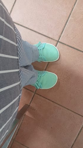 A top-down view of a customer wearing mint-colored Luck Ⅰ Barefoot Shoes on a tiled floor.