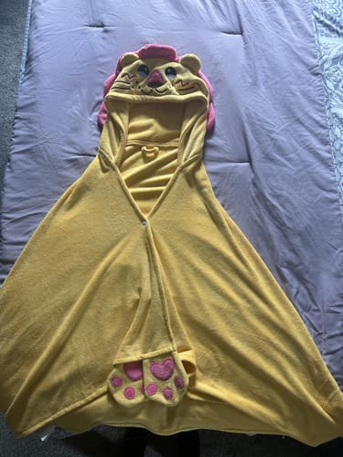 Customer's yellow lion hooded towel laid out flat, showing the cute lion face on the hood and paw-style hand pockets.