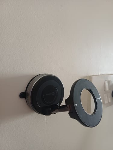 Customer's black MagPro Magnetic Phone Holder attached to a wall, showing the adjustable arm and magnetic ring.