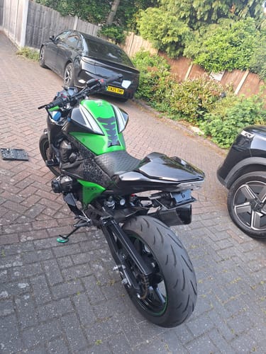 Reviewer's green and black Kawasaki Z800 motorcycle with the new tail tidy installed, showing a clean rear view.