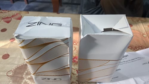 Customer's photo of two crushed and damaged white boxes of The Royal Oud Collection on a table.