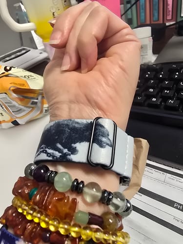 Reviewer's wrist wearing the patterned watchband, which is buckled tightly and covering part of the design.