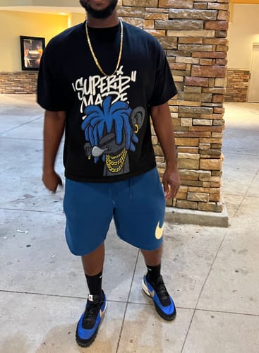 Reviewer wearing the black Thesupermade t-shirt featuring the blue dreadlock boy graphic.