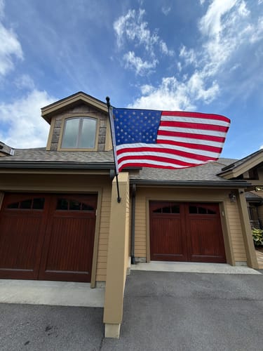Customer's beautiful Heavy Duty American Nylon Flag waving outside their home.